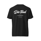 A black short-sleeve t-shirt shown from the back, featuring a white graphic print that reads 'Die Tired' in a cursive font, with smaller text underneath, displayed on a solid white background.